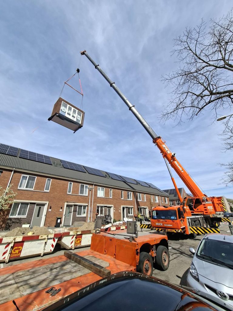 Grove GMK4100L-2 all-terrain crane lifting a prefab home extension over a house in Alkmaar, the Netherlands