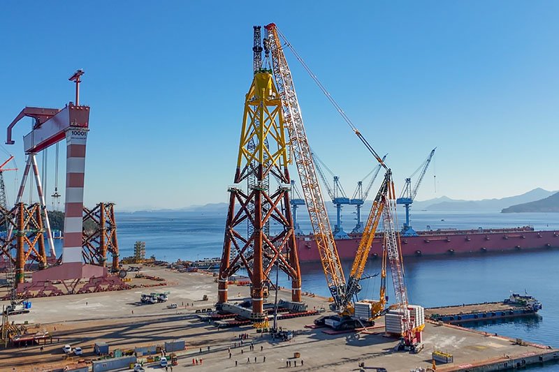 Liebherr LR 12500-1.0 crawler crane assembling jacket substructures at an offshore wind farm site in South Korea