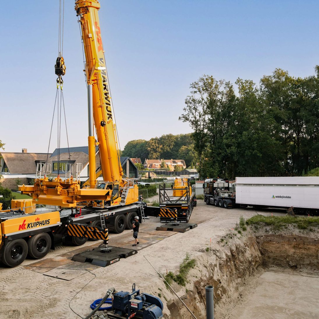 Liebherr LTM 1400-6.1 mobile crane self-assembling its counterweight in Oldenzaal, the Netherlands