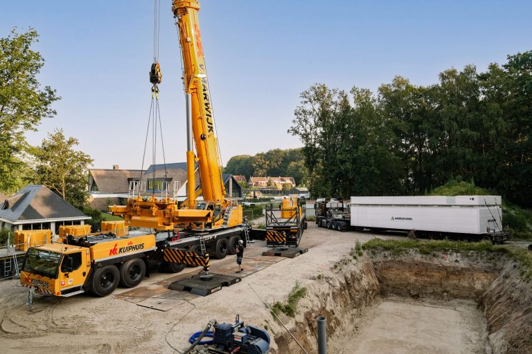 Liebherr LTM 1400-6.1 mobile crane self-assembling its counterweight in Oldenzaal, the Netherlands