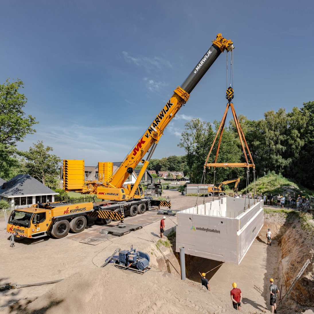 Liebherr LTM 1400-6.1 positioning the precast basement into the excavation pit in Oldenzaal