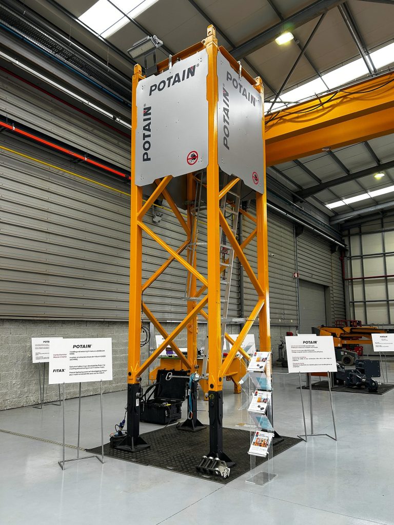 Potain tower crane mast section fitted with anti-intrusion panels on display