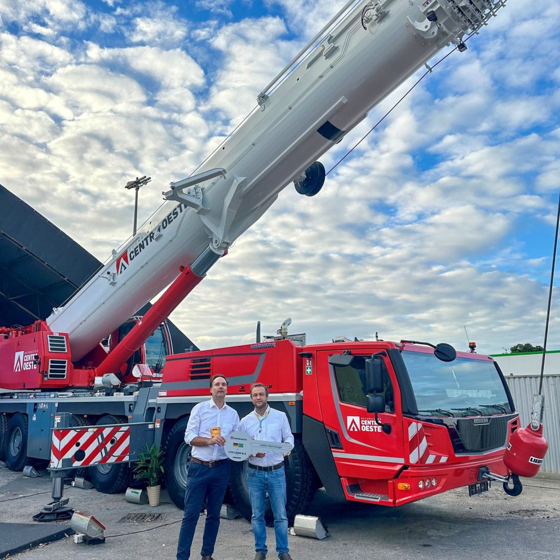 Handover of the Liebherr LTM 1300-6.4 mobile crane to Centro Oeste, with Fabio Azevedo of Liebherr Brasil and Denis Scopel of Centro Oeste