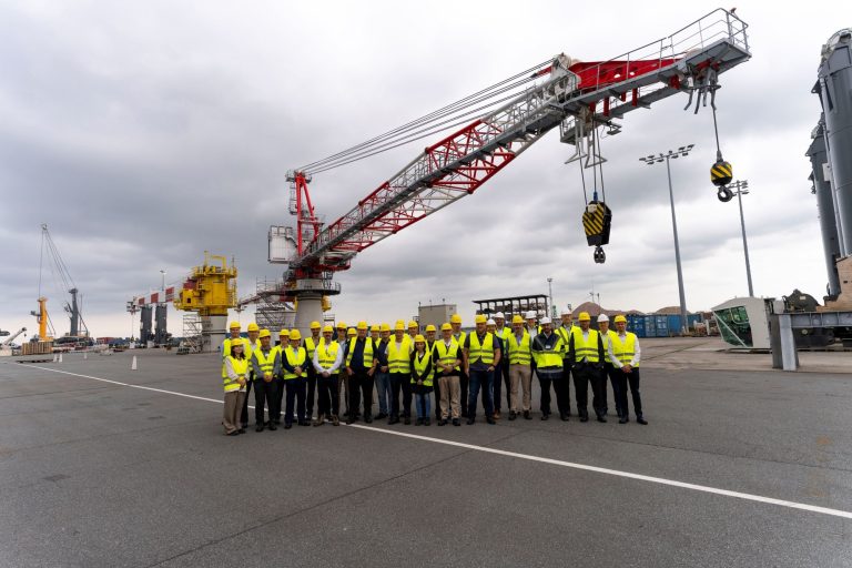 Participants at the Liebherr Offshore Summit 2026 in Rostock, with the electric BOS 4600 E offshore crane on show