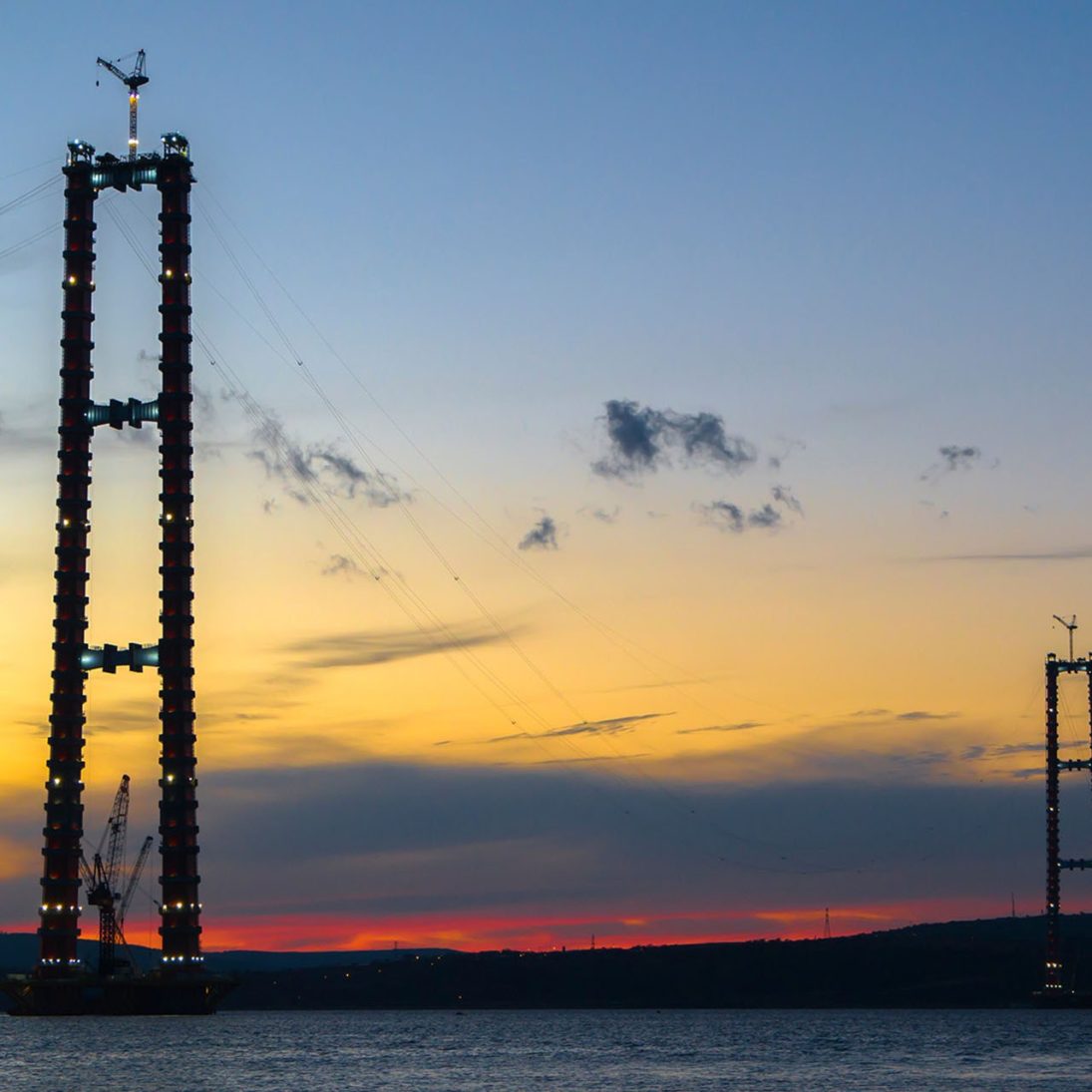 Two Liebherr 357 HC-L luffing jib tower cranes on a pylon of the Canakkale Bridge in Turkiye