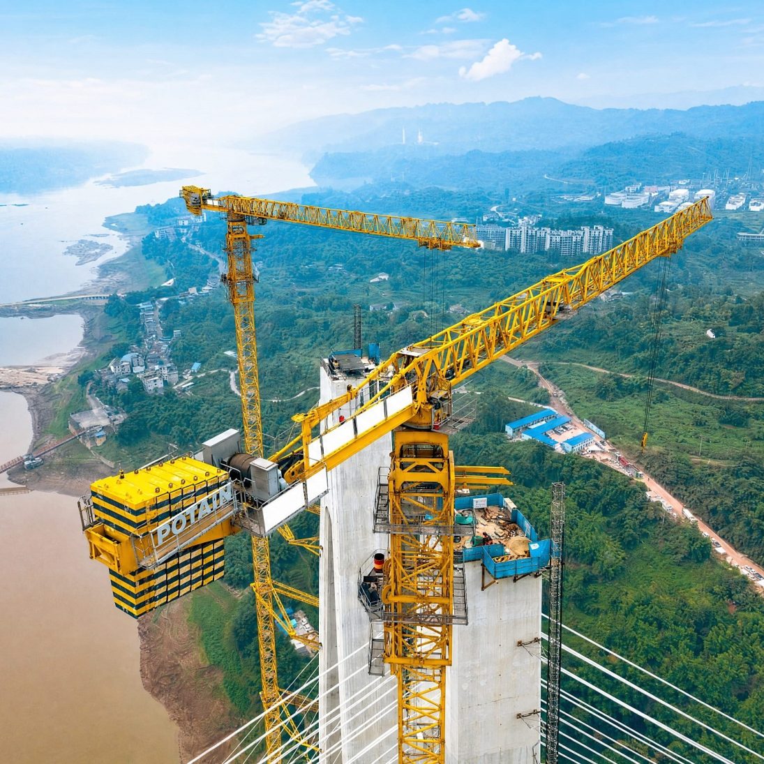 Potain MCT 560 M25 topless tower cranes on the south tower of the Shituo Yangtze River Bridge in Chongqing, China