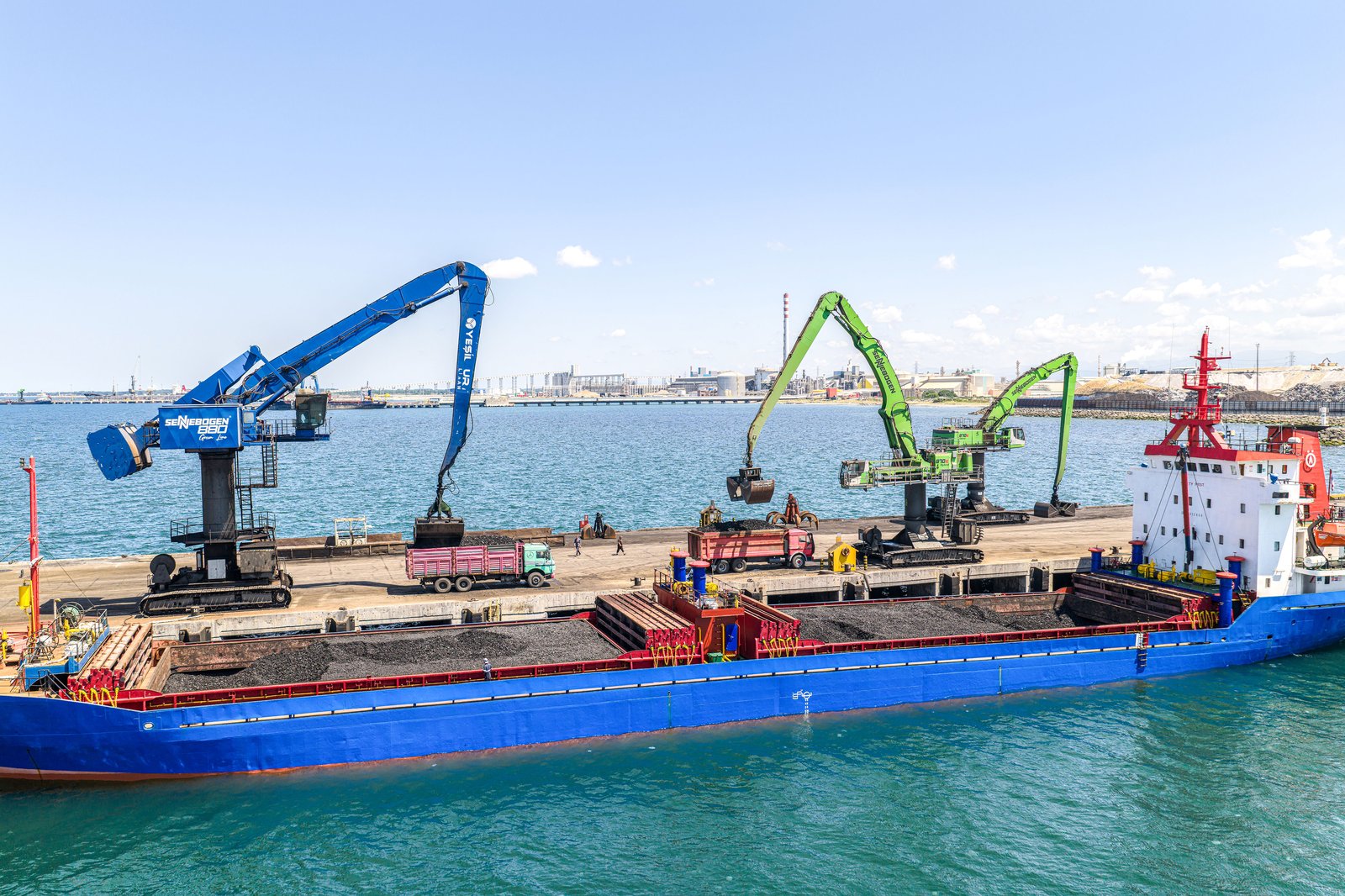 Sennebogen material handlers unloading a bulk carrier at Yesilyurt deep-sea port near Samsun, Turkey