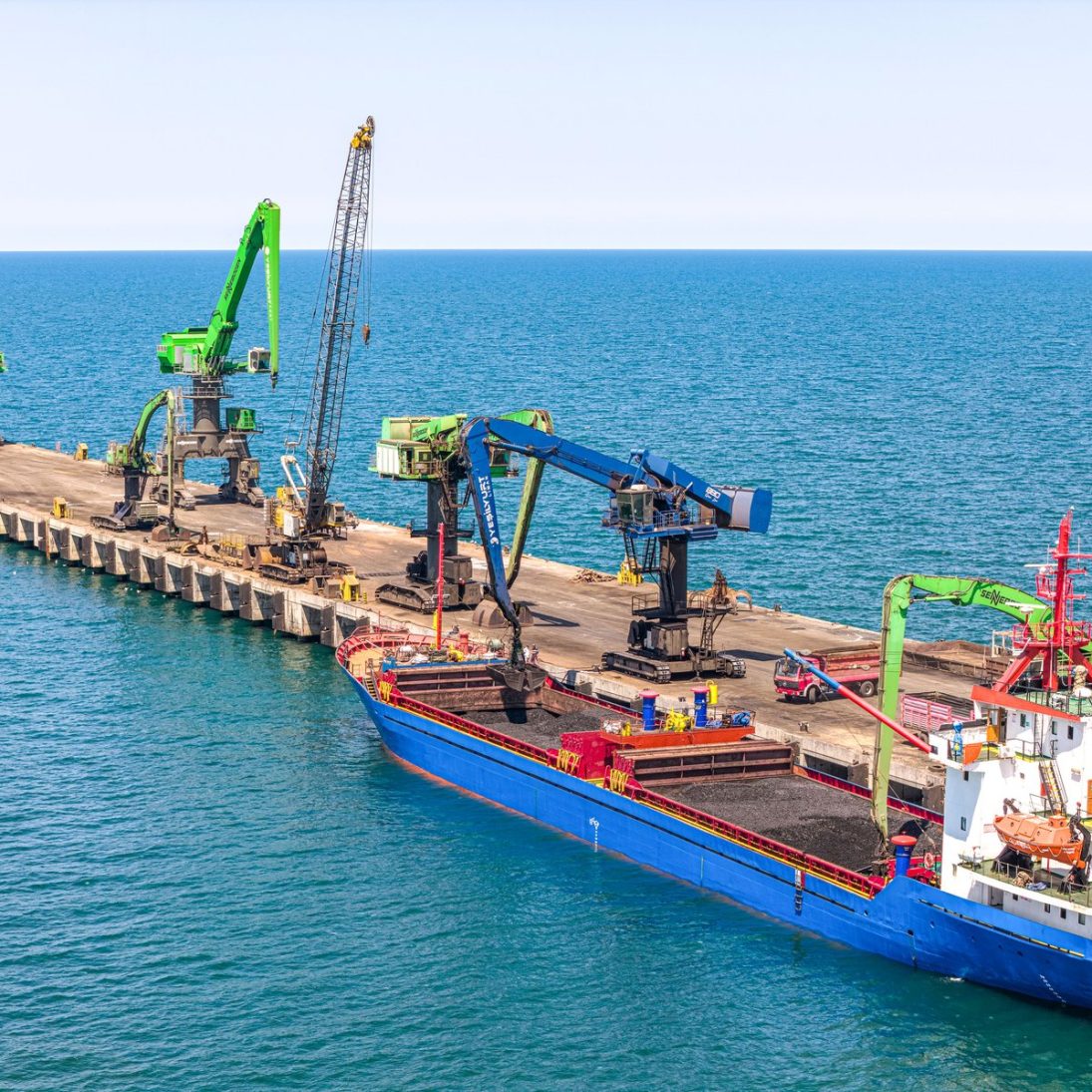 Sennebogen material handler fleet working a vessel on the pier at Yesilyurt deep-sea port on the Black Sea