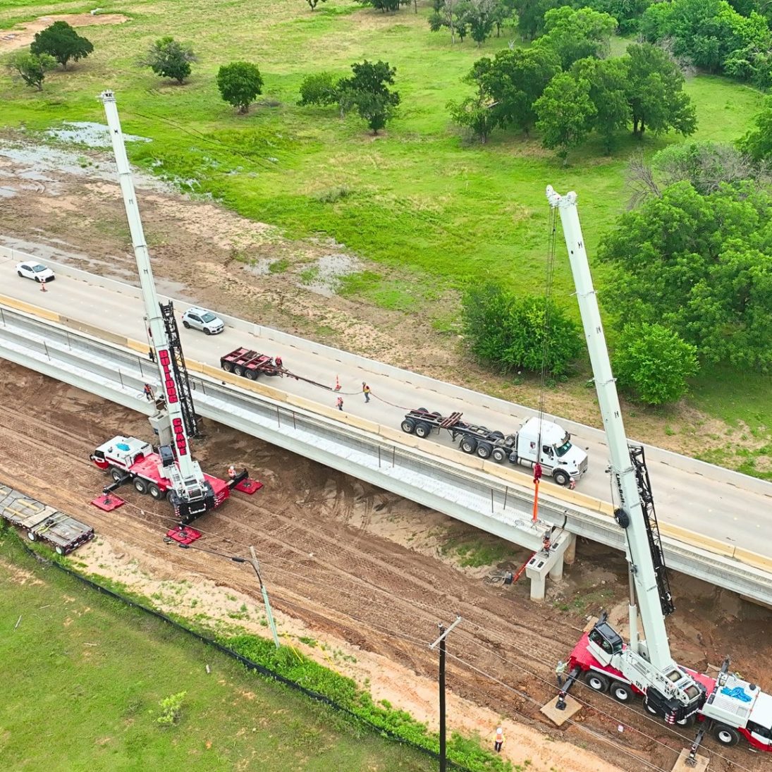 Two Link-Belt 175|AT all terrain cranes tandem lifting a bridge beam on the FM 730 project in Boyd, Texas