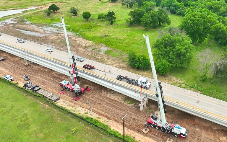 Two Link-Belt 175|AT all terrain cranes tandem lifting a bridge beam on the FM 730 project in Boyd, Texas