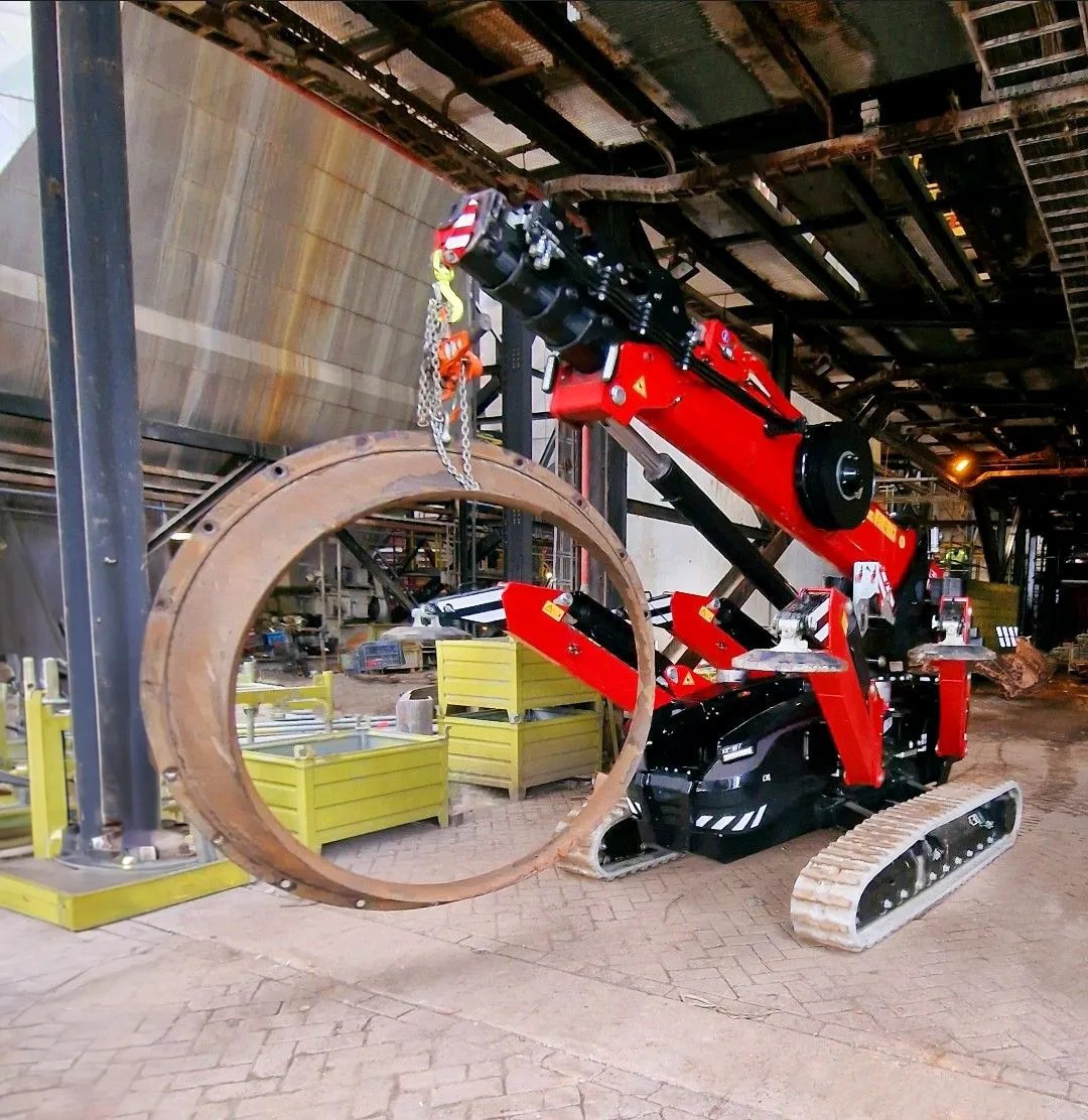 Hoeflon C30e mini crane lifting a steel ring inside a production facility