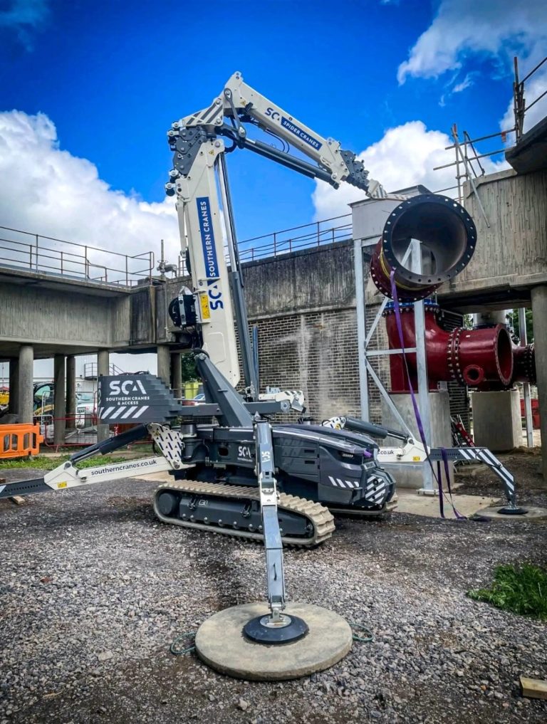 Hoeflon spider crane of Southern Cranes & Access lifting a large pipe section at an industrial site