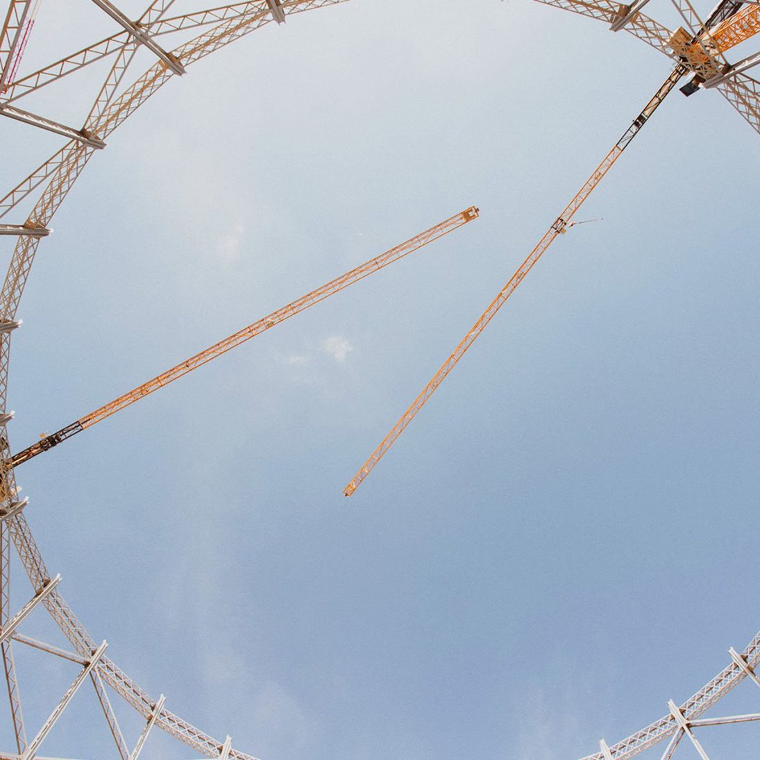 Three Liebherr EC-B flat-top tower cranes over the Bovisa gasometer site in Milan
