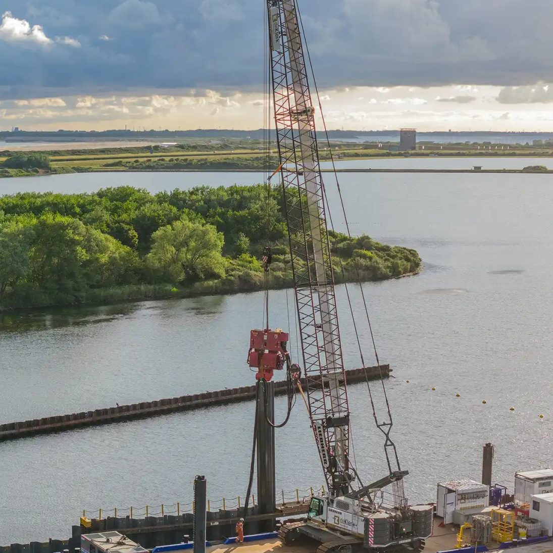 The battery-powered Liebherr LR 1130.1 unplugged working from an electrically driven pontoon on the Brouwersdam