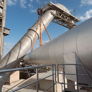 Liebherr LTM 1650-8.1 of Wiesbauer lifting a 33-tonne pipe with centimetres of clearance at the Holcim cement works in Dotternhausen
