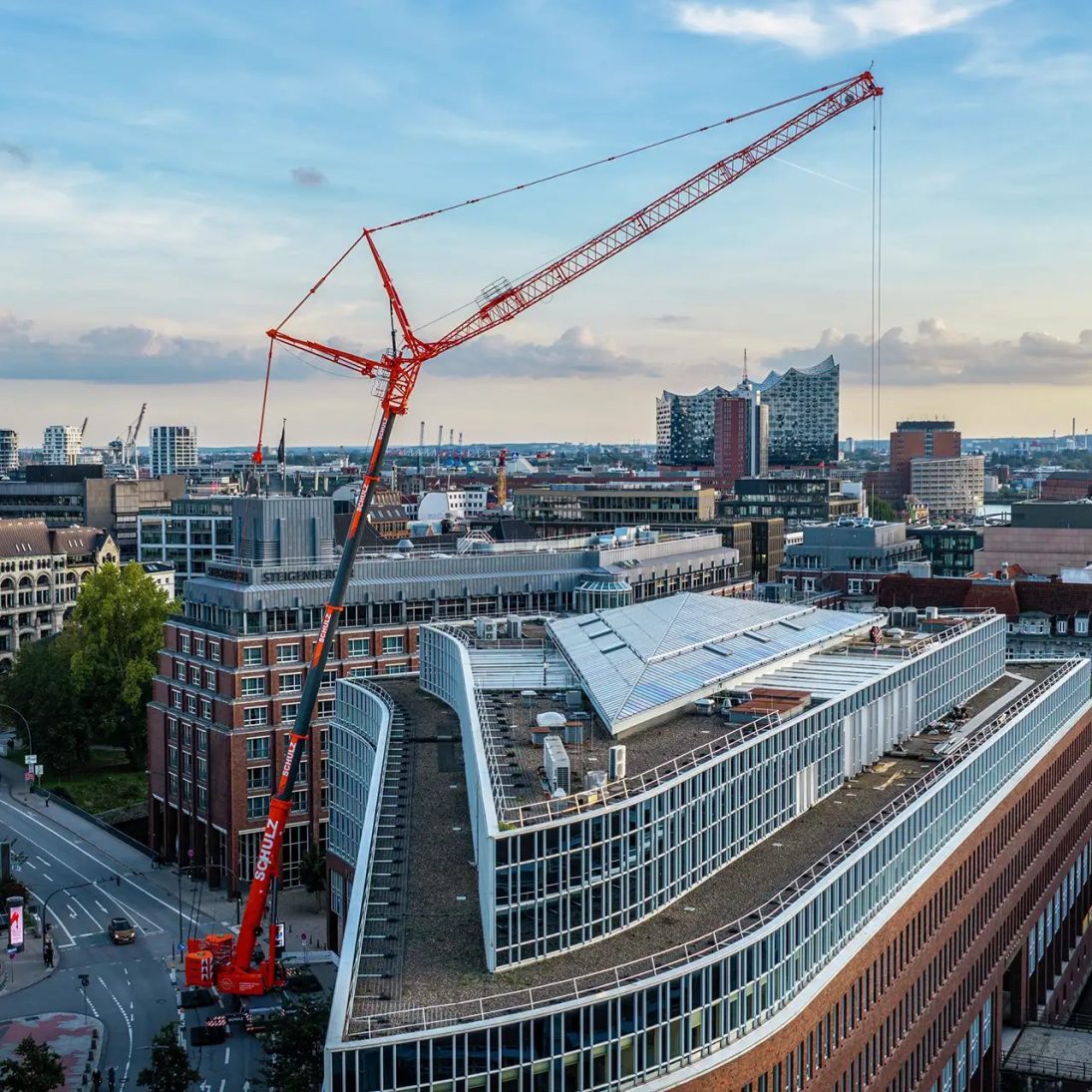 Liebherr LTM 1400-6.1 mobile crane of Krandienst Schulz lifting heat exchangers at the Fleethof in Hamburg, with the Elbphilharmonie in the background