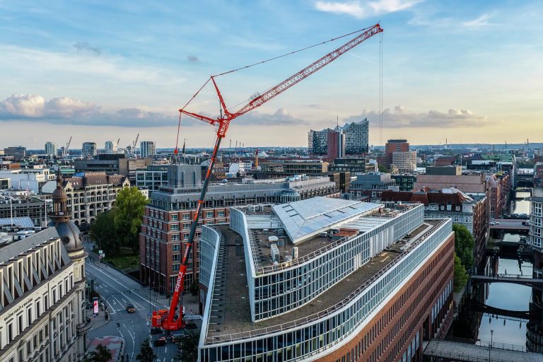 Liebherr LTM 1400-6.1 mobile crane of Krandienst Schulz lifting heat exchangers at the Fleethof in Hamburg, with the Elbphilharmonie in the background