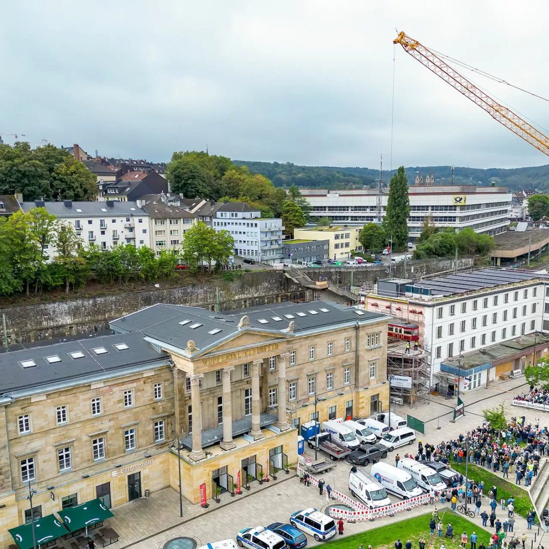 Liebherr LTM 1450-8.1 placing suspension railway carriage 76 on the forecourt of Wuppertal Central Station