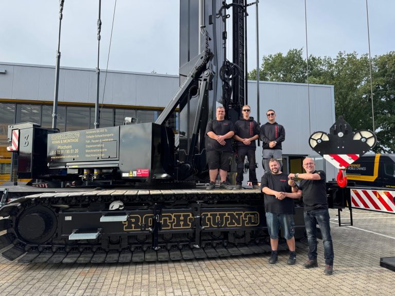 Spierings SK2400-R eLift crawler-mounted tower crane in black Rothmund GmbH livery at the key handover