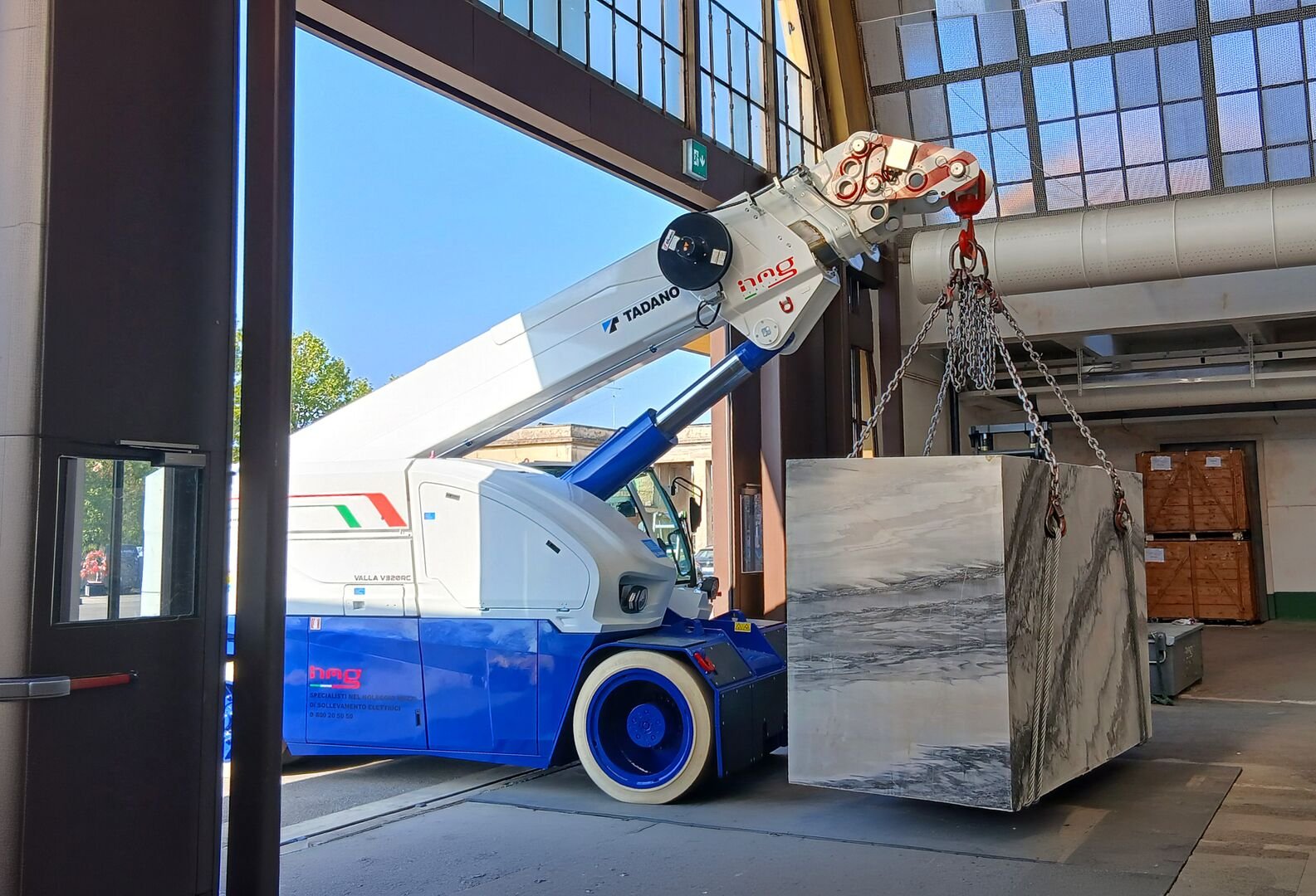 Tadano V320RC pick and carry crane working at the Marmomac trade fair in Verona
